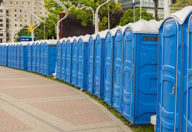 a row of portable restrooms set up for a large athletic event, allowing participants and spectators to easily take care of their needs in Bingen, WA